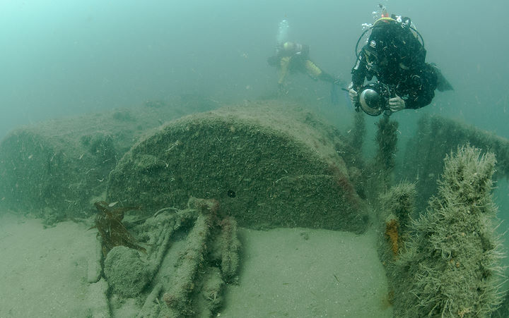 Photographer beside the forward boilers, <em>Iona II</em> shipwreck © Mike Deaton