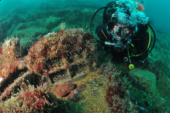 Diver investigating a brass artefact on the wreck of the Ethel © Mike Deaton